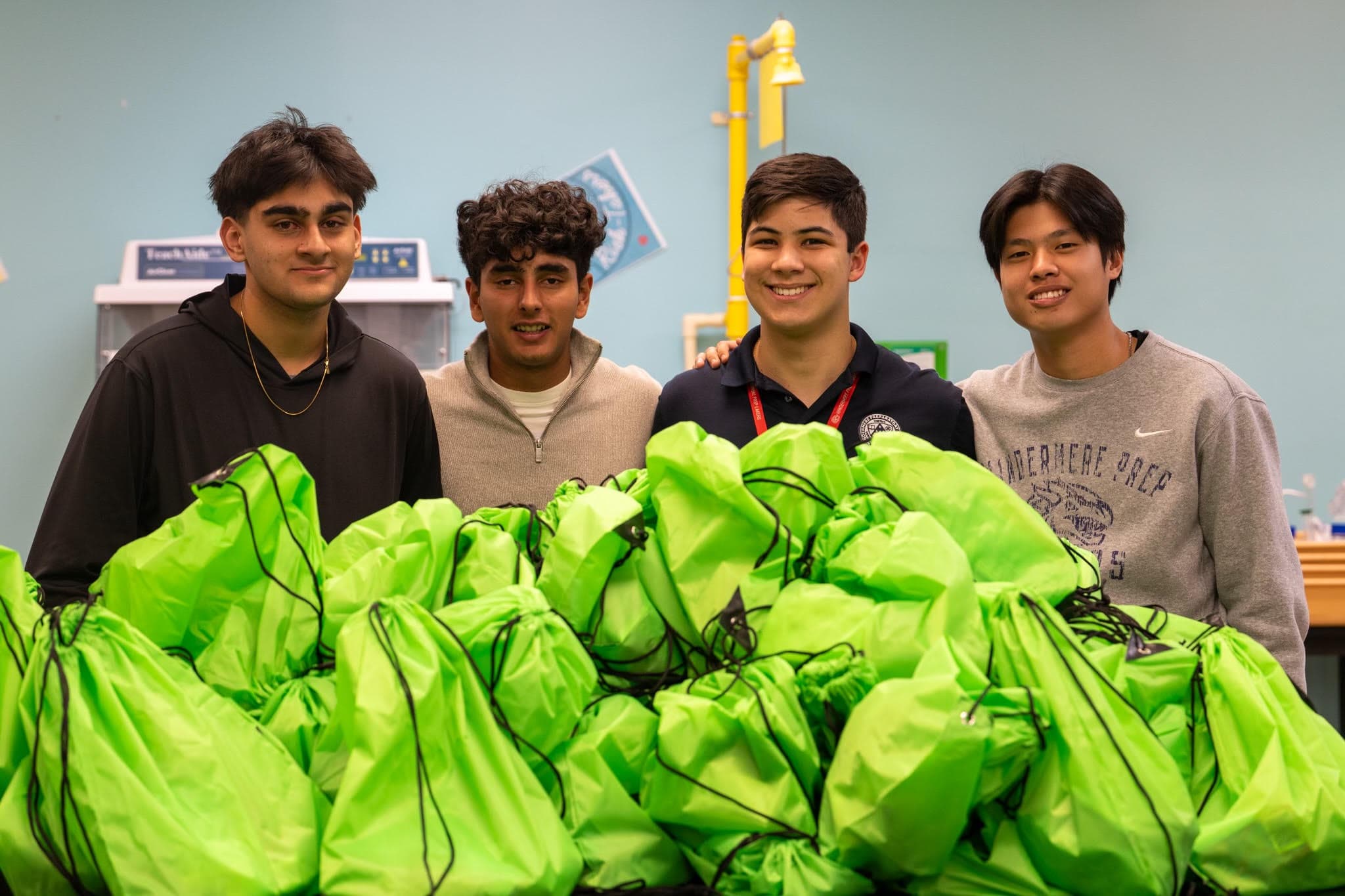 Green Guru Project volunteers holding green donation bags